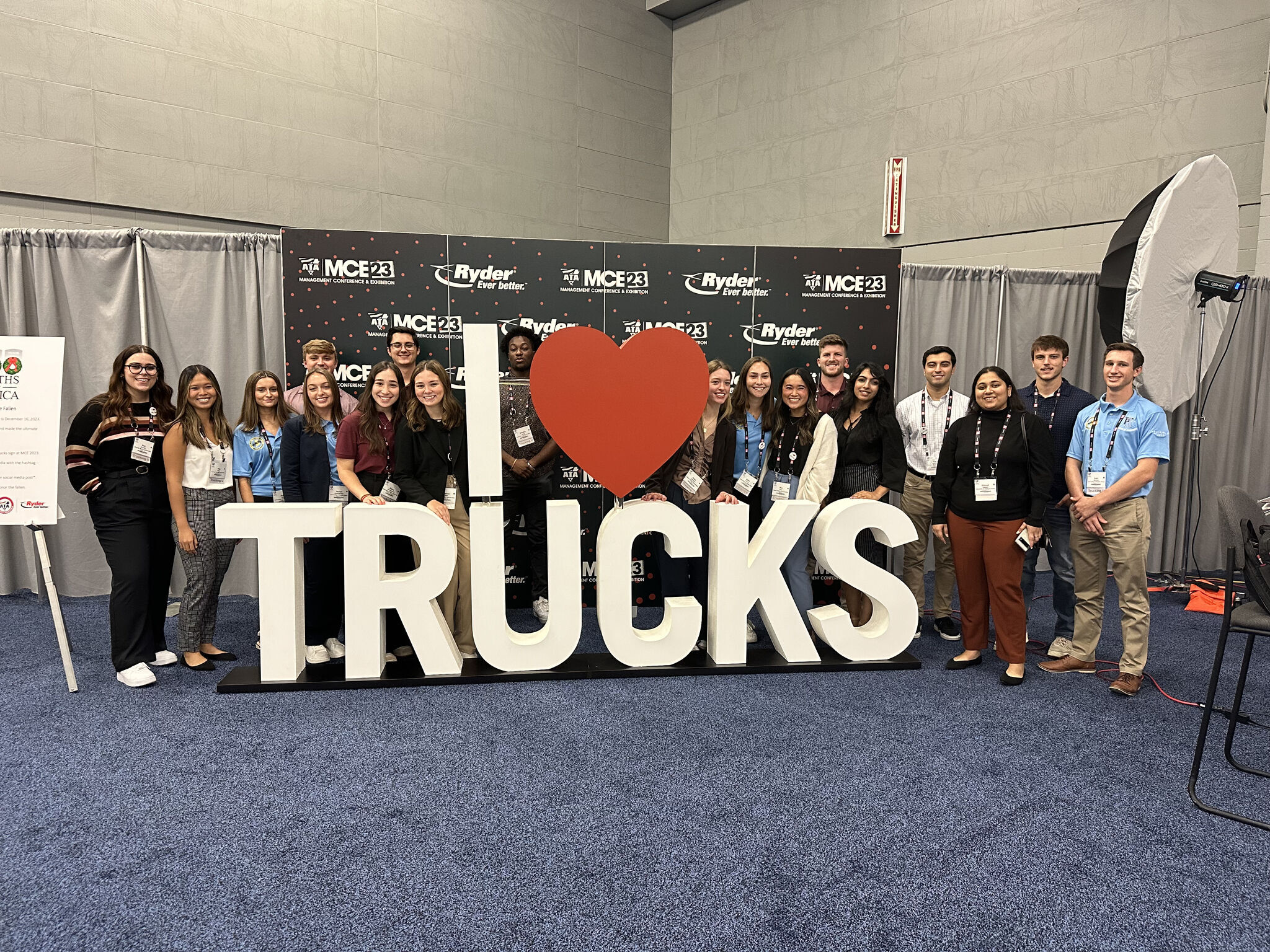 Trucking U 2023 Class in Front of I Heart Truck Sign